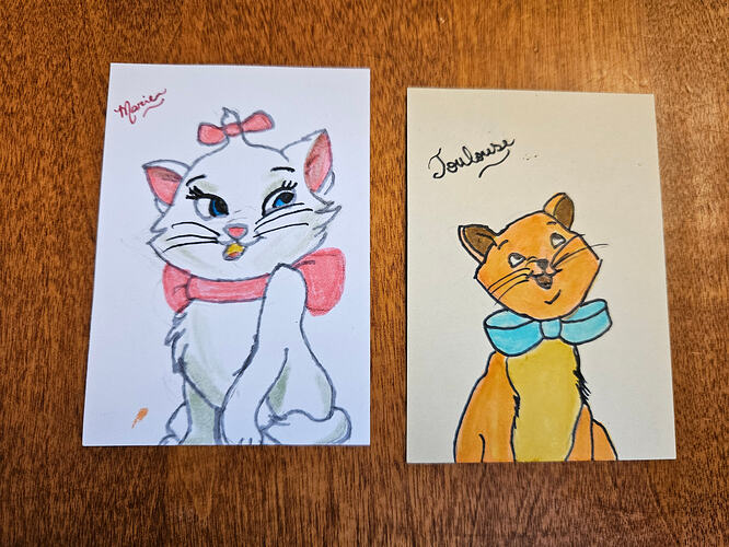 2 artist trading cards side by side, one of a white cat with pink details, and one of an orange tabby cat. Both cats are wearing bows. Based on Marie and Toulouse, 2 of the 3 kittens int he film Aristocats